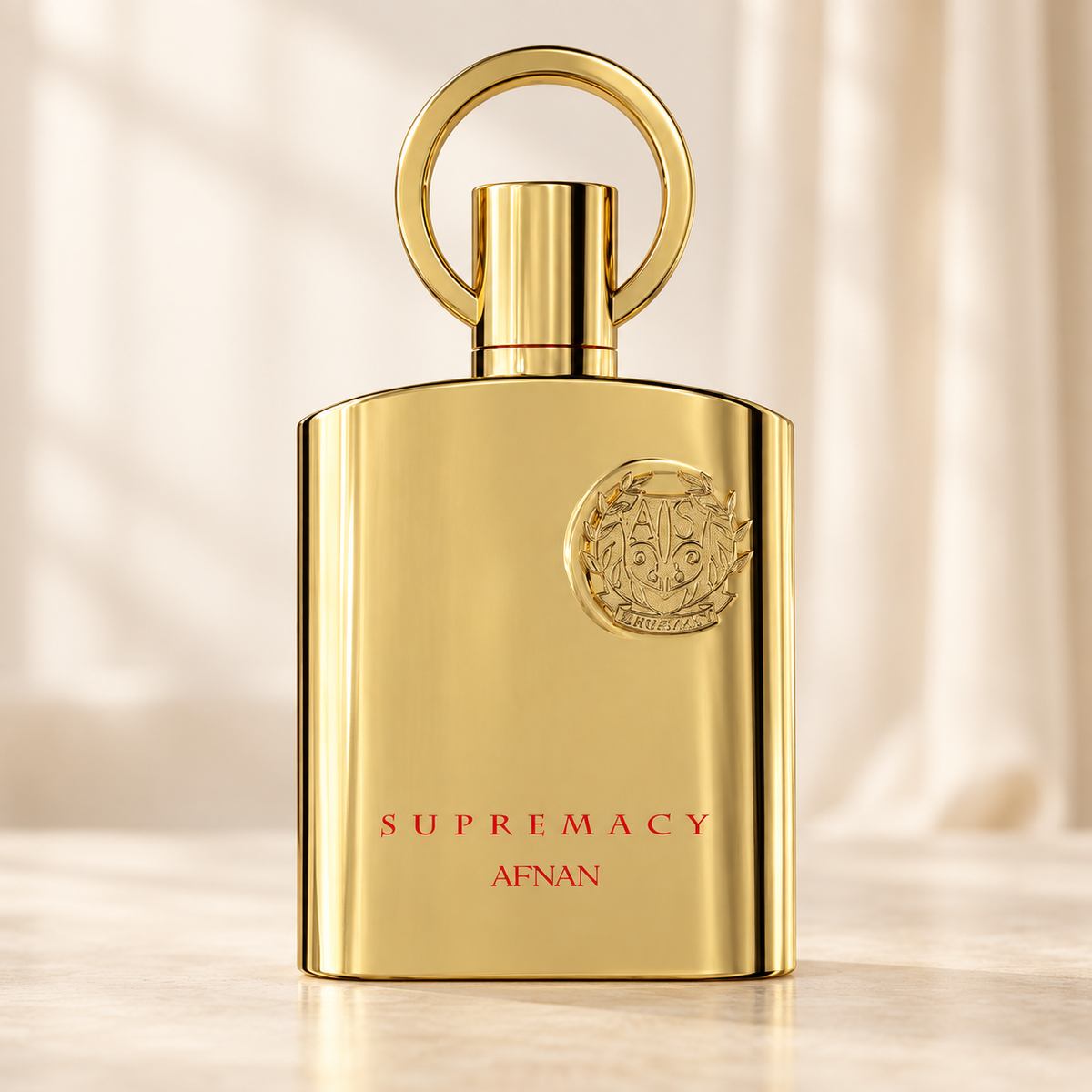 AFNAN - SUPREMACY GOLD, flacone frontale centrale ravvicinato con sfondo leggero
