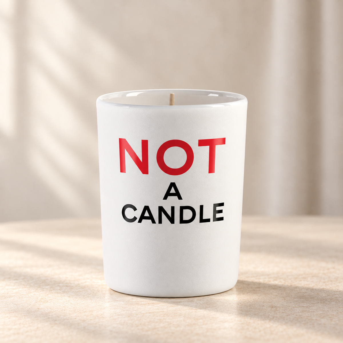 NOT A CANDLE di Juliette Has a Gun — prodotto su fondo beige, ambientazione creata con IA