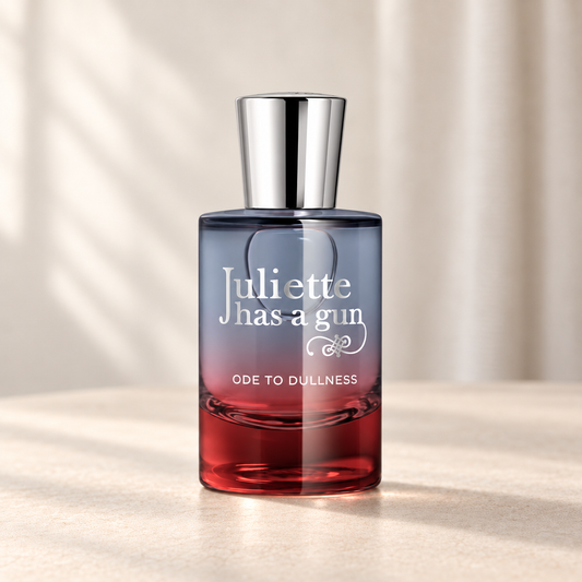 ODE TO DULLNESS di Juliette Has a Gun — flacone frontale su fondo beige, ambientazione creata con IA